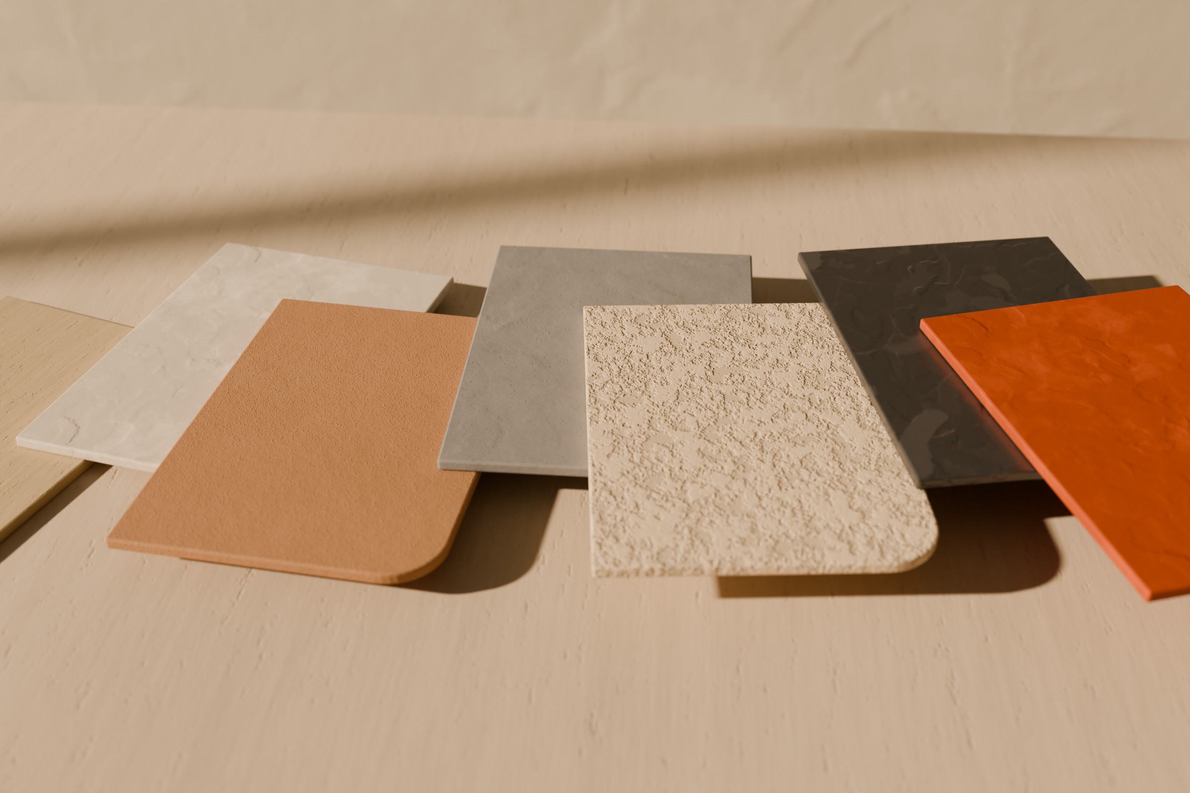 Concept render of sample boards in several finishes and colours fanned out on a stone table.