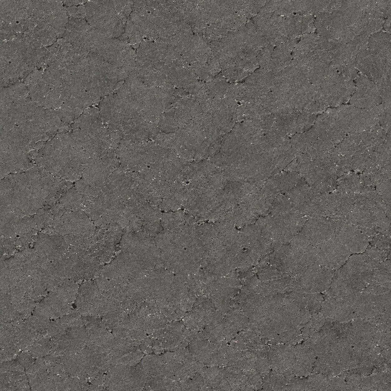 A dark charcoal-grey mineral surface with fine pores and subtle mottling.